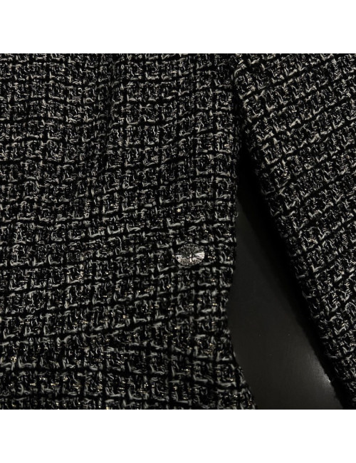 Veste T34 CHANEL en tweed noir et blanc avec fil doré. Fermeture avec zip et deux poches passepoilées sur le devant