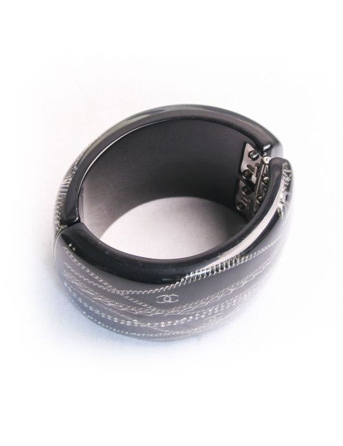 Manchette CHANEL noire avec inclusion chaînes et brillants