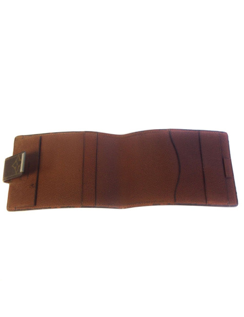 Wearing LOUIS VUITTON checkbook in monogrammed and leather coated canvas