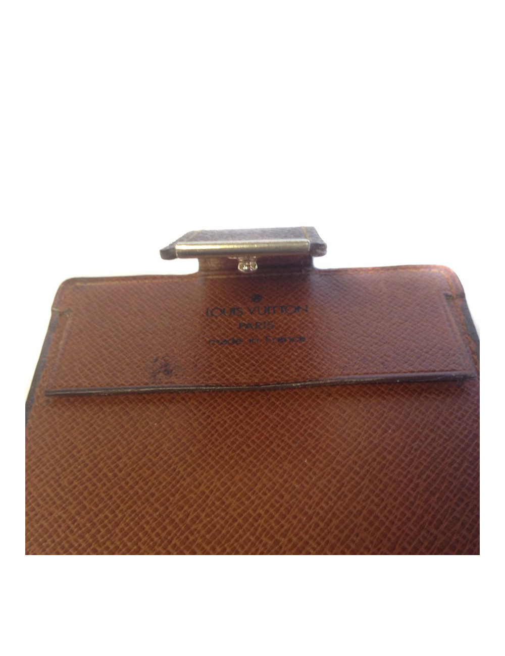 Wearing LOUIS VUITTON checkbook in monogrammed and leather coated canvas