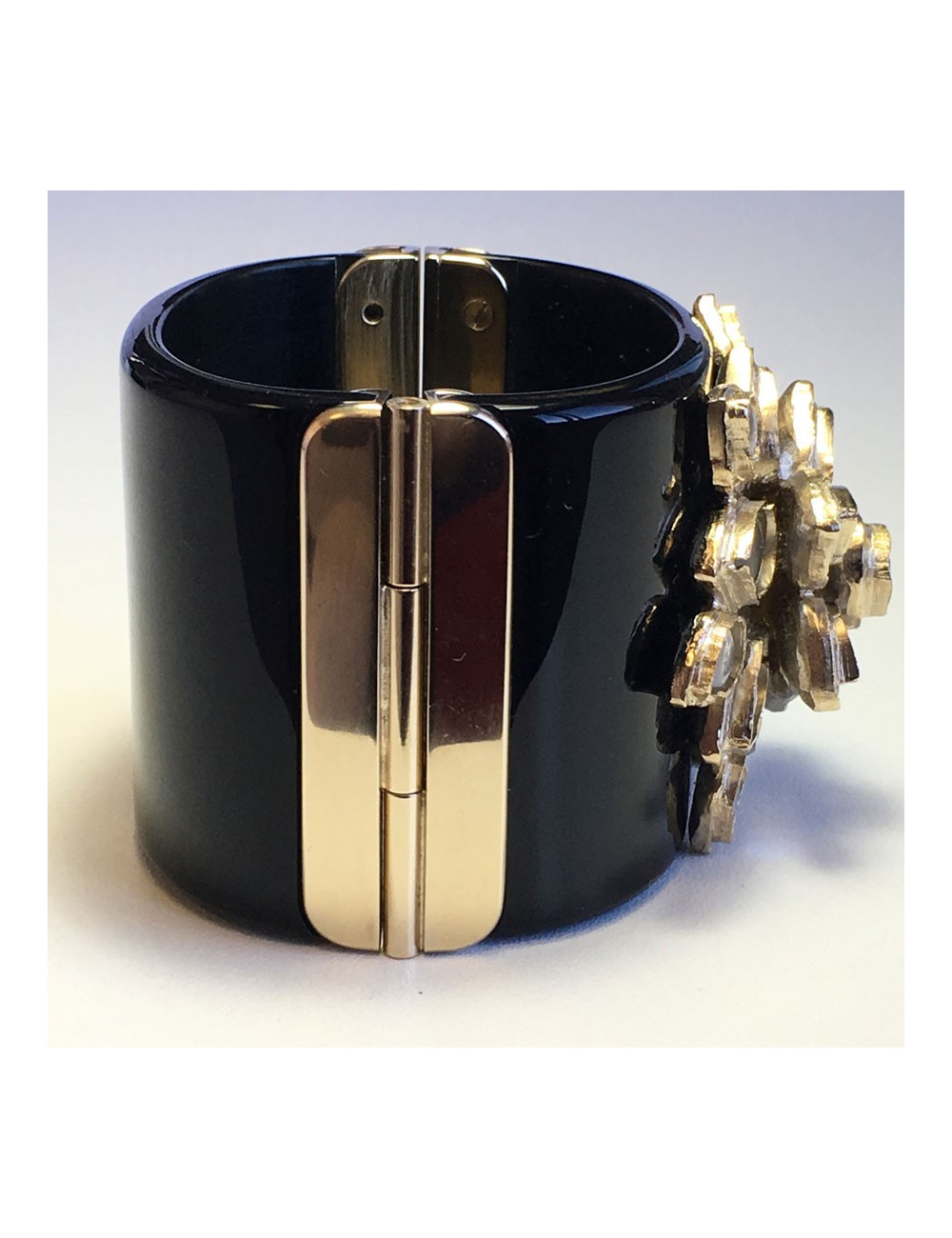 CHANEL cuff in black resin and flower in gold metal and transparent resin
