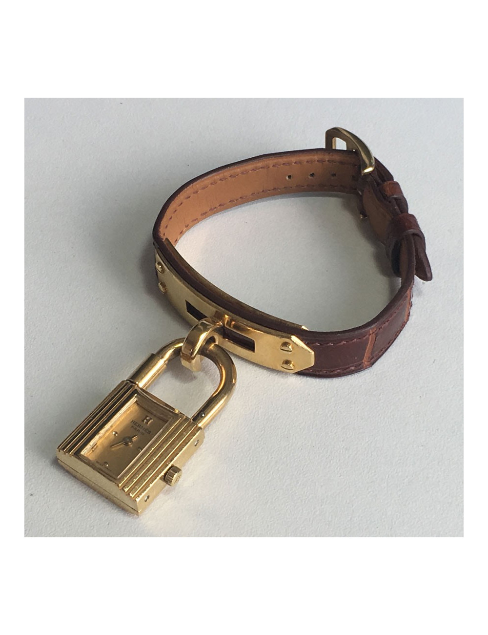 Montre Kelly HERMES bracelet en alligator marron et bijouterie plaqué or