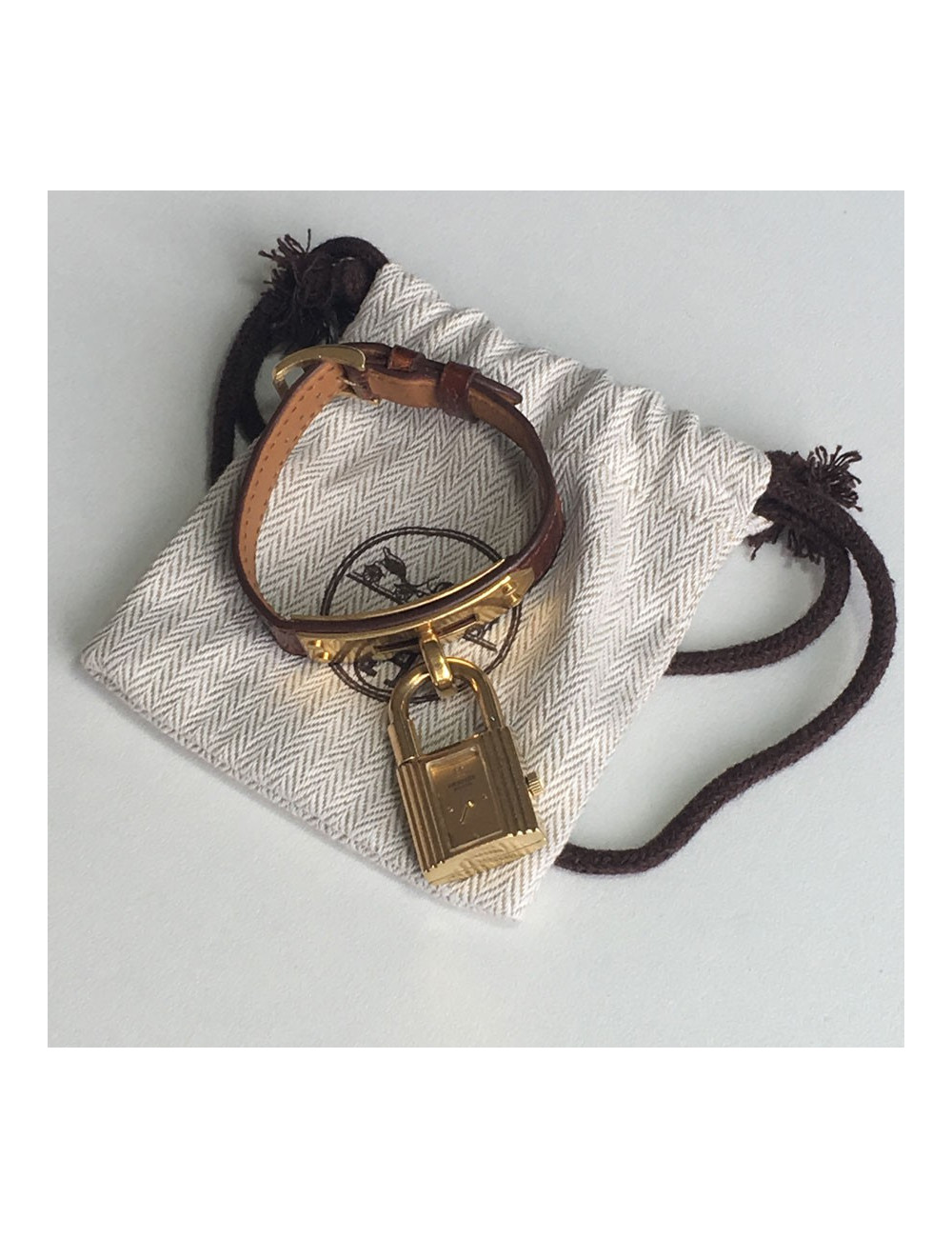 Montre Kelly HERMES bracelet en alligator marron et bijouterie plaqué or