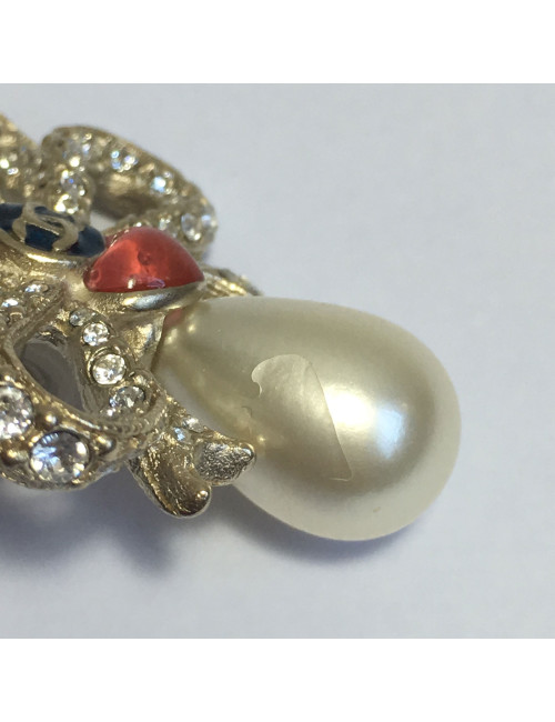 Boucles d'oreille clous CHANEL Noeuds et perle ovale nacrée