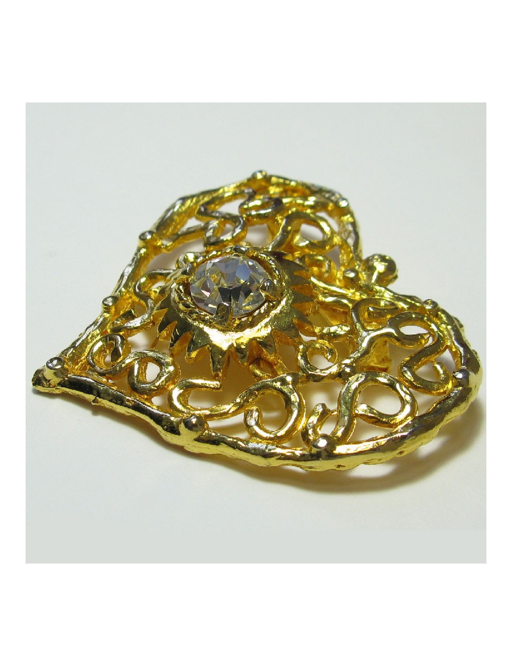 Broche CHRISTIAN LACROIX vintage coeur en métal doré serti d'un grand strass blanc au centre