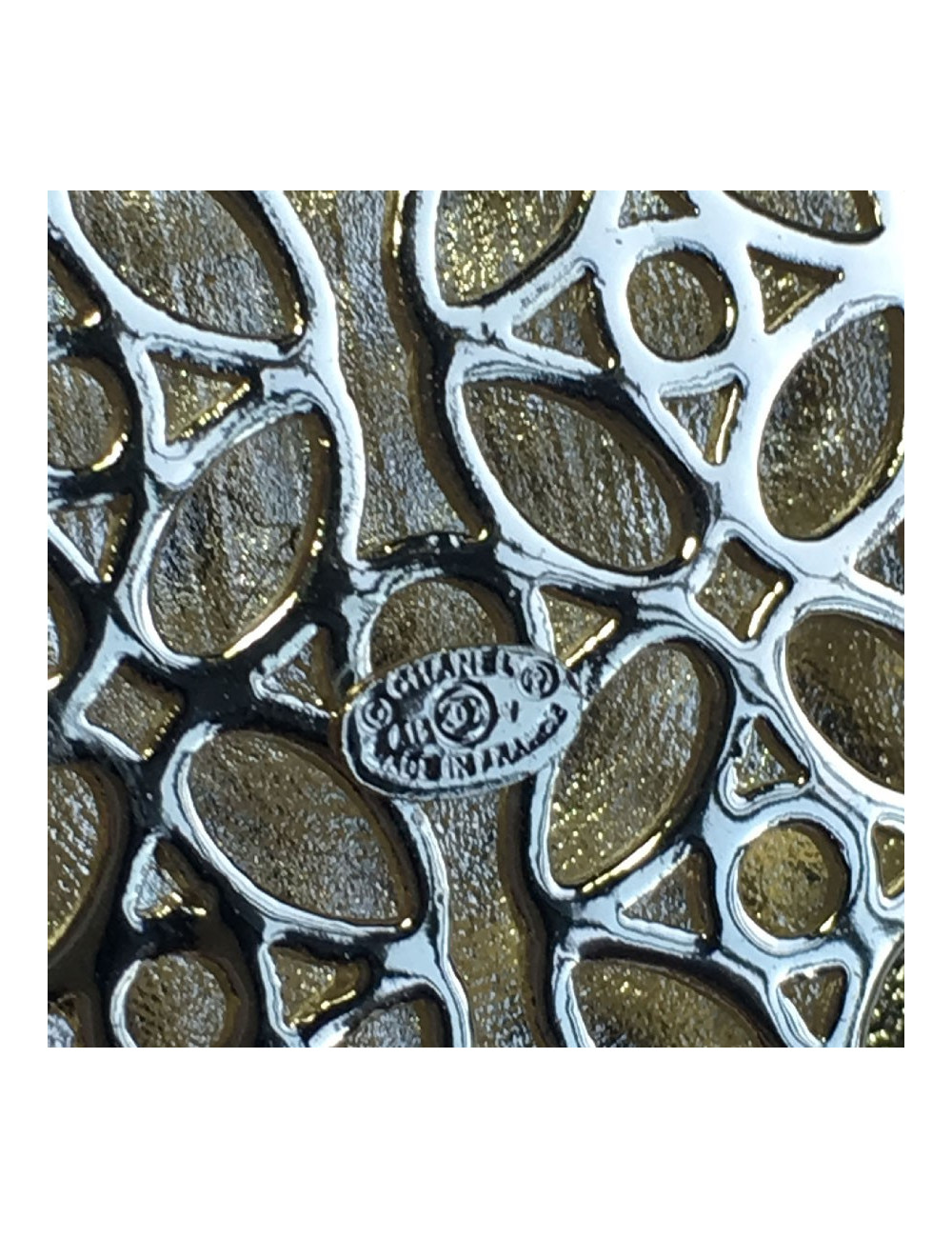 CHANEL escutcheon brooch in pale gilded metal, pearls and colored resin