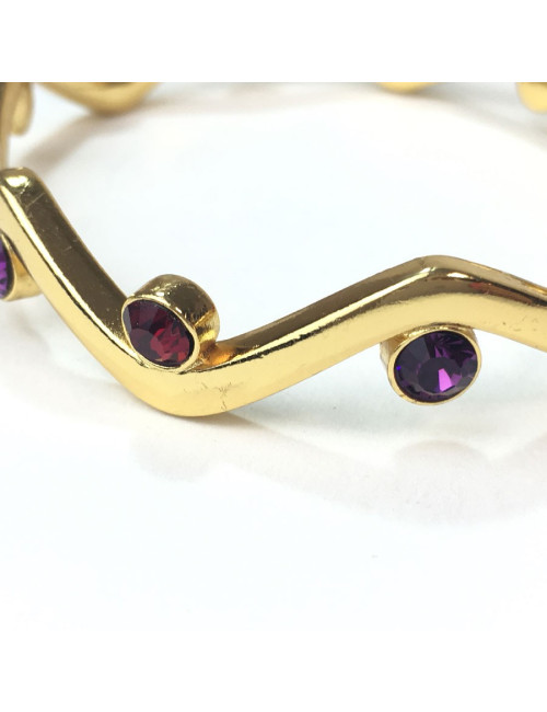 Bracelet rigide YVES SAINT LAURENT métal doré et strass rubis et améthyste